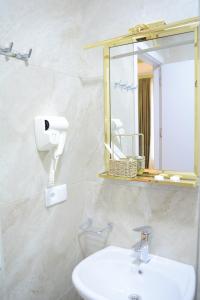 a bathroom with a sink and a mirror at Hotel Tabernei in Tbilisi City +56 photos