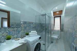 a bathroom with a washing machine in a shower at La MaGia Relax in Salerno