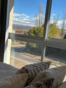 a room with a window with a view of a road at Depto con vista insuperable in Tupungato