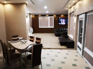 a dining room with a table and a living room at Black Sea Pearl in Chernomorets