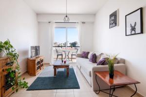 a living room with a couch and a table at Welcome! Perfect Location-City Center in Larnaca