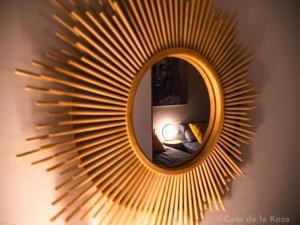 een spiegel met een zonnestralenspiegel aan de muur bij Casa de la Kosa in San Miguel de Abona