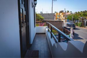 a door to a balcony with a view of a street at Cabo Lofts in Cabo San Lucas