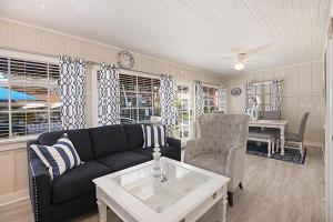 a living room with a couch and a table at 118 Emerald Ave A & B in Newport Beach +87 photos