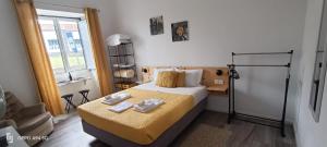 a bedroom with a bed with two towels on it at Seaside House in Ponta Delgada +55 photos