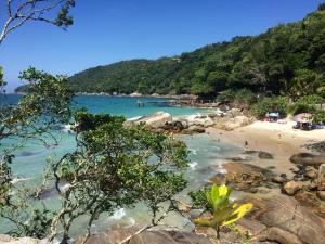 a beach with a group of people in the water at Dolce Vita in Porto Belo +16 photos