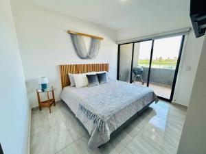a bedroom with a bed and a large window at moderno con alberca cerca de la playa by G P S rentas in Mazatlán +12 photos