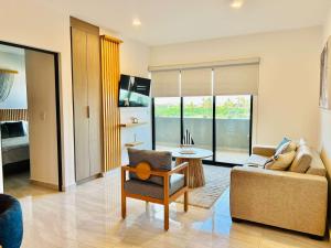a living room with a couch and a chair at moderno con alberca cerca de la playa by G P S rentas in Mazatlán