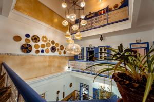 a staircase in a building with a potted plant at RIAD AMANA in Essaouira