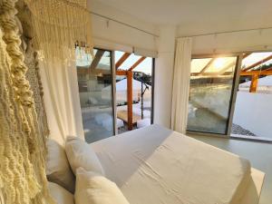 a bedroom with a bed and a large window at Meteora Superior Collection Villas III in Kalabaka +10 photos