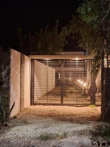 a gate to a house at night with lights at Los Paraísos Oro Verde in Oro Verde +5 photos