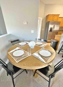 a wooden table with four chairs around it at Private Stylish Townhome near ISU & Hospital in Pocatello
