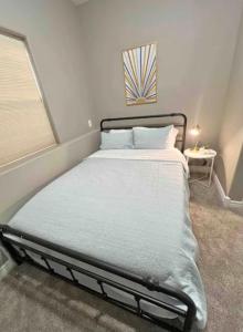 a bed in a small room with a window at Private Stylish Townhome near ISU & Hospital in Pocatello +7 photos