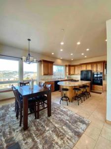 a large kitchen with a table and chairs in it at Luxury home w a View- biking and hiking near in Pocatello