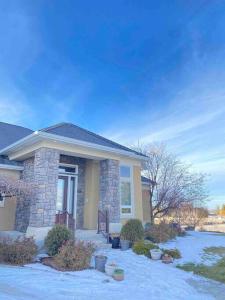 a house with snow on the ground in front of it at Luxury home w a View- biking and hiking near in Pocatello