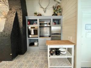 a room with a kitchen with a counter and a door at Whitewater Cottage- IN TOWN walk to everything in Lava Hot Springs +12 photos