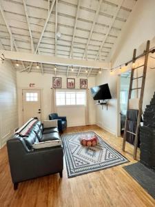 a living room with a couch and a rug at Whitewater Cottage- IN TOWN walk to everything in Lava Hot Springs