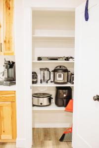 a kitchen pantry with pots and pans on shelves at Creekside Cabins- Birch stylish stay w views in McCammon