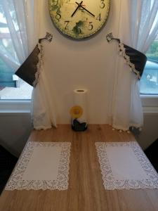two white mats on the floor with a clock on the wall at Mobile Home CARMINO in Turda +35 photos