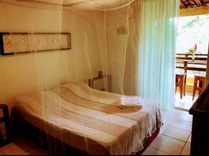 Cama ou camas em um quarto em Casa de Hospedagem "Praia e Coqueiros"