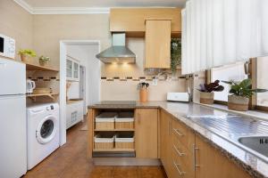 a kitchen with a sink and a dishwasher at Maré Baixa Oceanside Apartment in Nazaré +16 photos