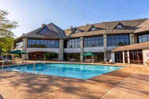 a large building with a swimming pool in front of it at Lost Creek Haven in Branson West