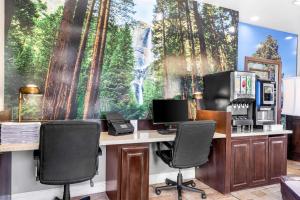 an office with a desk with two monitors and chairs at Best Western Plus Yosemite Way Station in Mariposa