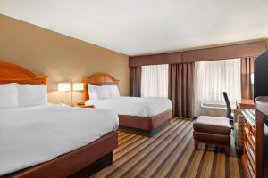 a hotel room with two beds and a television at Best Western Rockland in Rockland