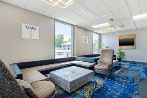 a living room with a couch and chairs and a tv at Best Western Franklin in Franklin
