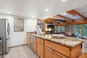 a kitchen with a large island with a counter top at Lodge at Lionshead 110-100 in Vail