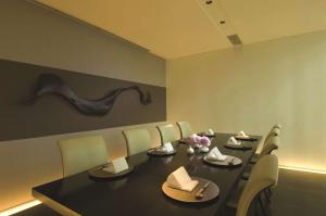 a dining room with a black table and chairs at Conrad Tokyo in Tokyo