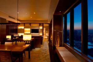 a living room with a view of a city at Conrad Tokyo in Tokyo