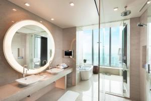 a bathroom with two sinks and a large mirror at Conrad Tokyo in Tokyo