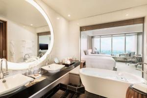 a bathroom with two sinks and a large mirror at Conrad Tokyo in Tokyo