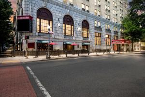 an empty street in front of a large building at Genetti Hotel, SureStay Collection by Best Western in Williamsport