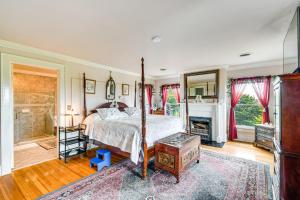 a bedroom with a bed and a fireplace at Geneva Vacation Rental with Vineyard and Lake Views! in Geneva