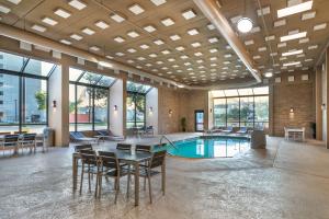 a large room with a table and chairs and a pool at Best Western Plus Houston Energy Corridor in Houston