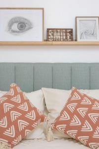 a shelf above a bed with pillows on it at Maré Baixa Oceanside Apartment in Nazaré
