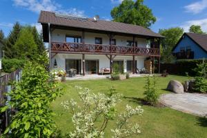 a house with a deck and a yard at Spreewaldferienwohnungen in Lübben