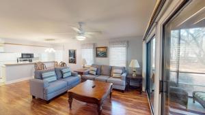 a living room with two couches and a table at Golf Lover's Haven Modern One-Bedroom Suites in Pawleys Island +12 photos