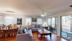 a living room with a couch and a table at Golf Lover's Haven Modern One-Bedroom Suites in Pawleys Island
