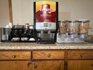 a kitchen counter with a mixer and a box of food at Boomtown Inn in Drumright