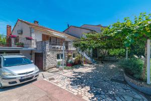 a car parked in front of a house at Apartments with parking space Fazana - 18334 in Fažana