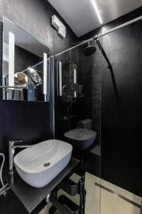 a bathroom with a white sink and a mirror at Family friendly house with a swimming pool Dolinci, Crikvenica - 23065 in Grižane +12 photos