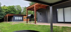 a house with a large screen in the yard at Cabaña Coyam in Villa del Dique +1 photo