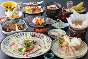 a bunch of plates of food on a table at Biwako Grand Hotel Kyo-Ohmi in Otsu