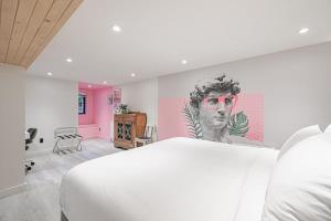 a bedroom with a white bed and a painting on the wall at Spa Oasis in Toronto's Heart-Free Parking! and Pet Friendly in Toronto +58 photos
