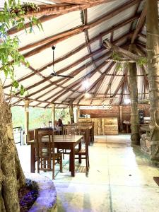 a wooden dining room with a table and chairs at Birds Paradise Inn in Udawalawe +133 photos