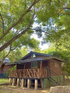 a house with a balcony on the front of it at Birds Paradise Inn in Udawalawe