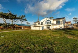 a large white house with a large yard at Perch - Sierra Retreat 34 in Coupeville